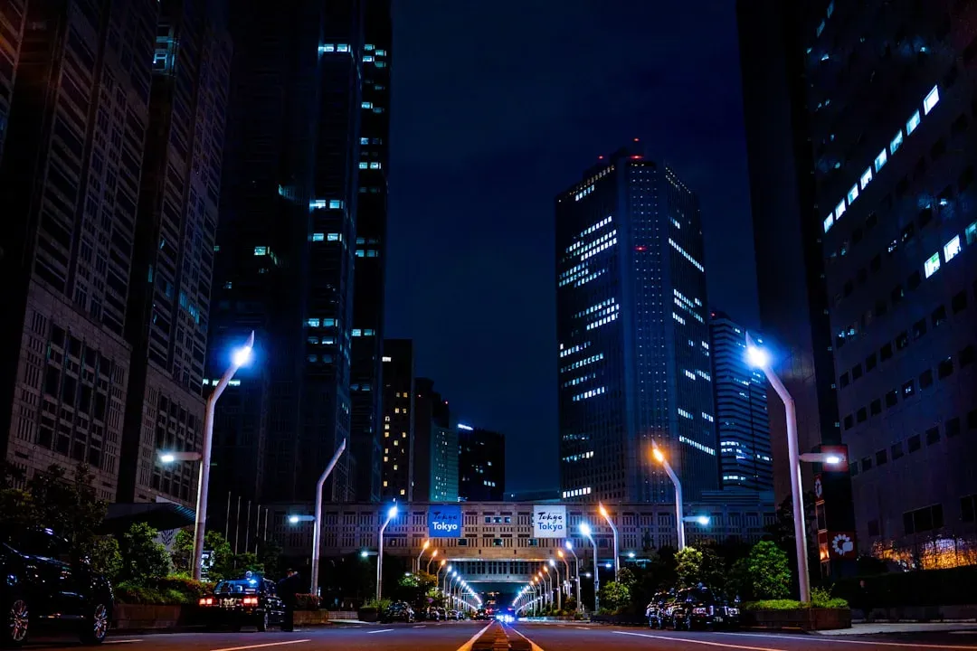 neon lights reflecting off wet city street at night